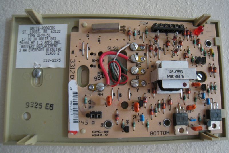 The wall-mount portion of a digital thermostat, with the cover off.